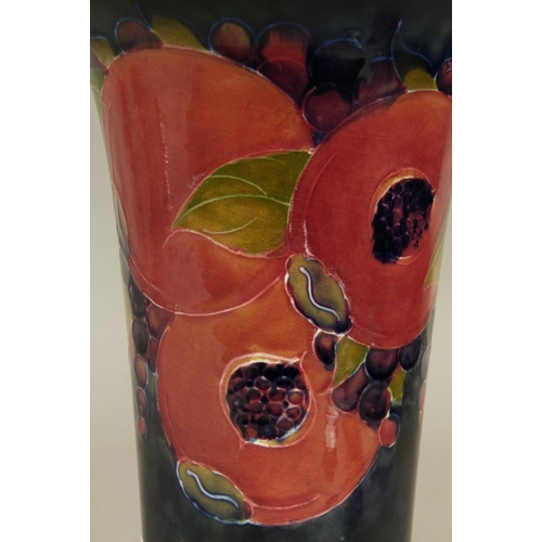 190 - A WILLIAM MOORCROFT POMEGRANATE DESIGN VASE c.1916, tapered cylindrical form with flared rim and on ... 