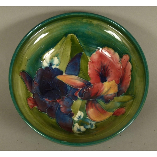 191 - A WALTER MOORCROFT ORCHID DESIGN BOWL c.1975 circular, on foot rim, tubelined and glazed in mauve an... 