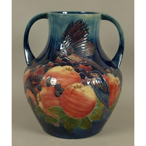 192 - A WALTER MOORCROFT FINCHES AND BERRIES DESIGN TWO HANDLED VASE c.1988 tubelined and glazed in pink a... 