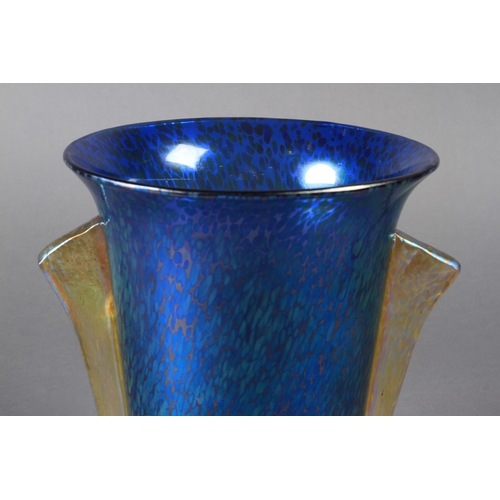 196 - A LARGE LOETZ IRIDESCENT BLUE GLASS two handled vase of Art Deco style, the flared body with pair of... 