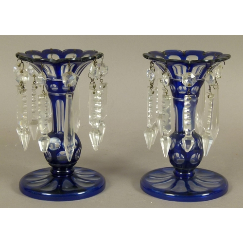 199 - A PAIR OF VICTORIAN BLUE CASED AND CLEAR GLASS LUSTRES, the knopped stem having a flared neck with s... 