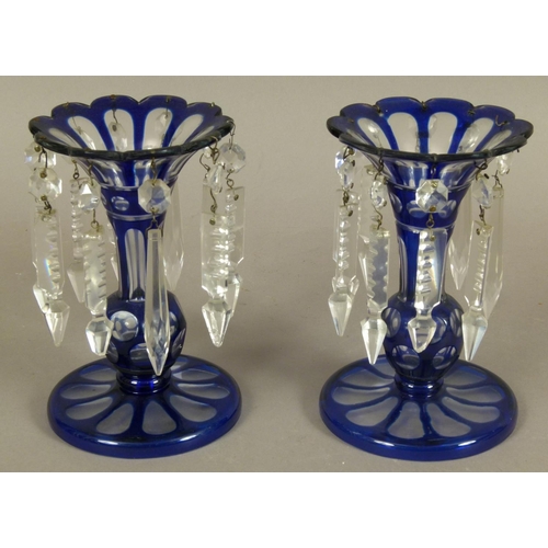 199 - A PAIR OF VICTORIAN BLUE CASED AND CLEAR GLASS LUSTRES, the knopped stem having a flared neck with s... 