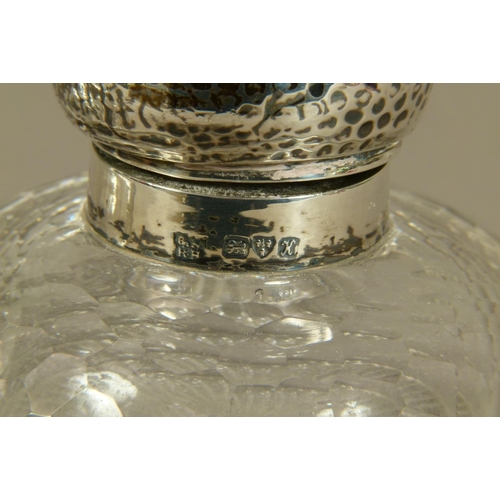 200 - A PAIR OF GEORGE V SILVER LIDDED GLASS INKWELLS of domed circular form with honeycomb faceted decora... 