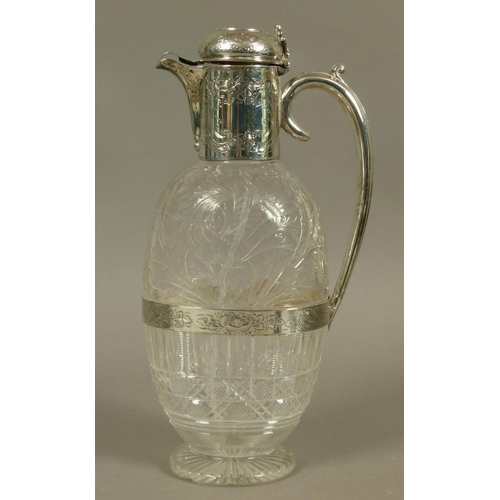 201 - A LATE VICTORIAN SILVER MOUNTED CRYSTAL CLARET JUG of oval flattened form, the semi-domed cover with... 