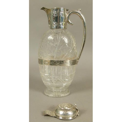 201 - A LATE VICTORIAN SILVER MOUNTED CRYSTAL CLARET JUG of oval flattened form, the semi-domed cover with... 