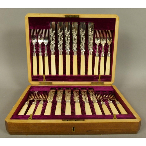 208 - A LATE VICTORIAN MAHOGANY CANTEEN of twelve silver plated and ivory handled fish knives and forks by... 