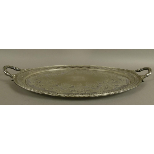 215 - A VICTORIAN SILVER PLATED TWO HANDLED TRAY of oval outline, engraved to the centre with a coat of ar... 