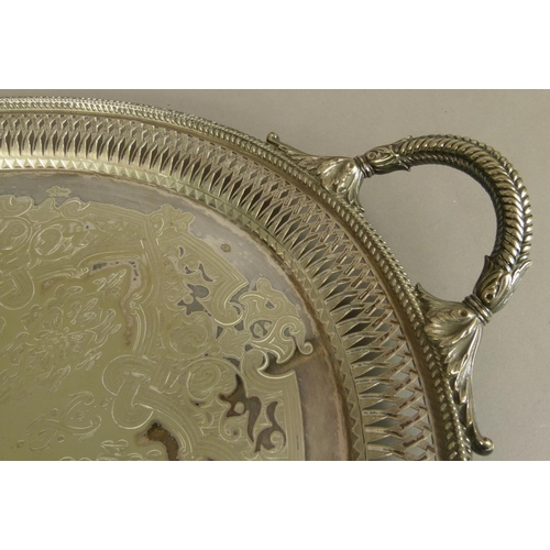 215 - A VICTORIAN SILVER PLATED TWO HANDLED TRAY of oval outline, engraved to the centre with a coat of ar... 