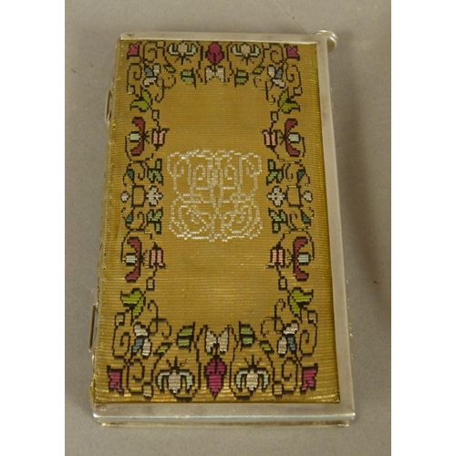 227 - A SILVER MOUNTED AND GILT METAL CLOTH NOTE BOOK AND STYLUS , 10cm high x 5.25cm together with a silv... 