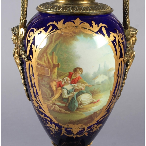 23 - A LATE 19TH CENTURY ORMOLU MOUNTED PORCELAIN VASE, the urn shaped body painted to the front with a y... 