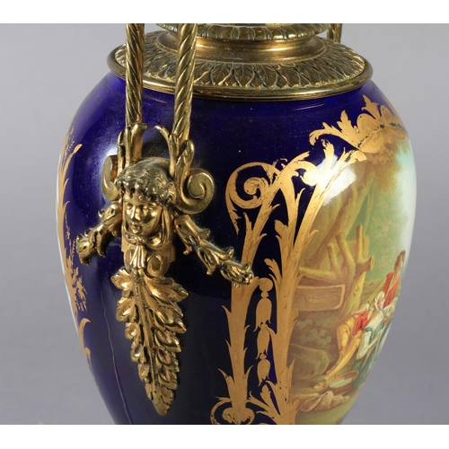 23 - A LATE 19TH CENTURY ORMOLU MOUNTED PORCELAIN VASE, the urn shaped body painted to the front with a y... 