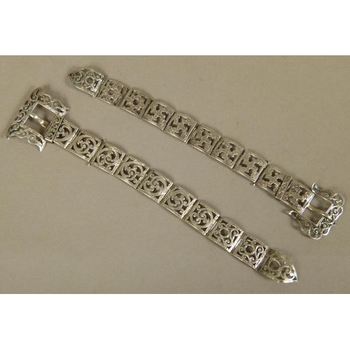 237 - AN INTERESTING PAIR OF SCOTTISH SILVER COLOURED METAL SOCK BELTS with buckles, each square link foli... 