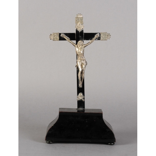 249 - A FRENCH OR ITALIAN SILVER AND EBONISED WOOD CRUCIFIX, on a bombe-shaped stand with bun feet, 30.5cm... 