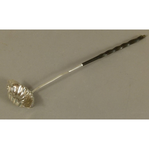 260 - A CONTINENTAL SILVER COLOURED METAL LADLE of fluted elongated oval form, the silver stem terminating... 