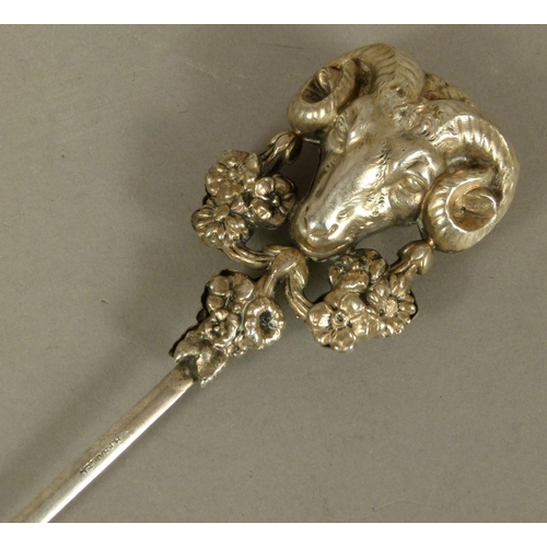 262 - A CONTINENTAL SILVER COLOURED METAL MEAT SKEWER, the terminal embossed with a ram mask, hung floral ... 