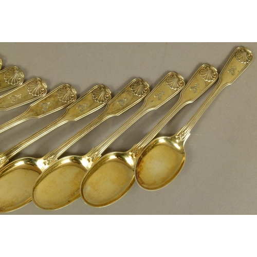 263 - A SET OF TWELVE SILVER GILT .800 TEASPOONS of fiddle, thread and shell pattern, by Hessenberg, engra... 