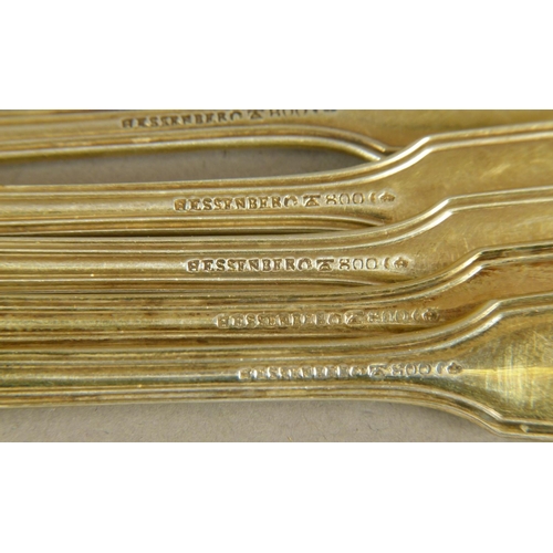 263 - A SET OF TWELVE SILVER GILT .800 TEASPOONS of fiddle, thread and shell pattern, by Hessenberg, engra... 