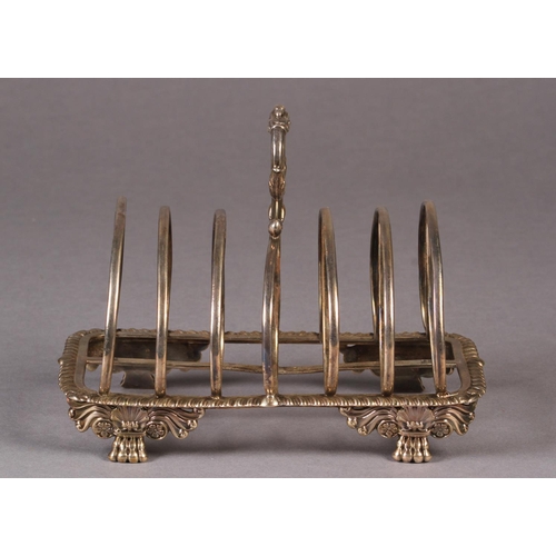 271 - A GEORGE IV SILVER SEVEN BAR TOAST RACK, by William Eley, London 1930, of arched form with leaf capp... 