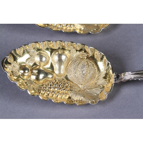 278 - A PAIR OF VICTORIAN SILVER 'BERRY' SPOONS, with fine cast lambrequin terminals, the neck and handles... 