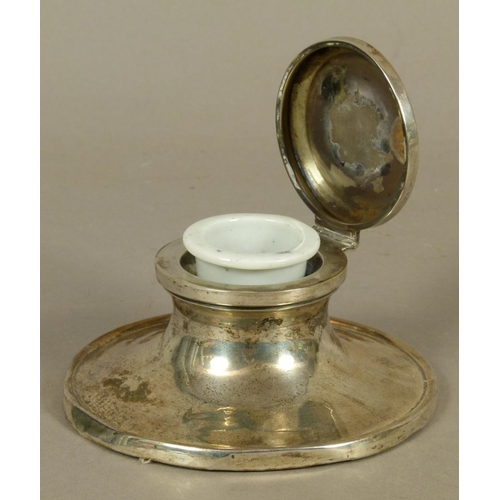 289 - A GEORGE V SILVER CAPSTAN INKWELL of conventional form, the hinged lid engraved with SS emblem withi... 