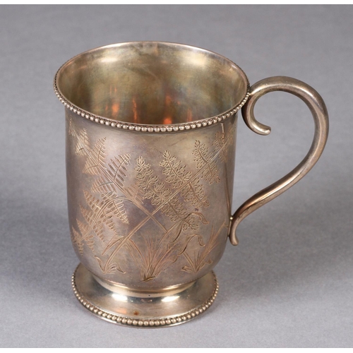 298 - A MID VICTORIAN SILVER CHRISTENING MUG London 1870, having a beaded rim and foot, engraved with fern... 