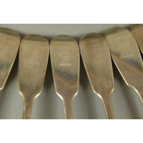 312 - ELEVEN MID VICTORIAN FIDDLE PATTERN TABLESPOONS engraved with crests by George Adams, London 1868, a... 