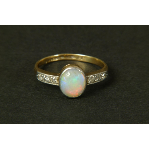 320 - AN OPAL AND DIAMOND RING, c.1950 in 18ct gold and platinum, the oval opal cabochon collet set to the... 