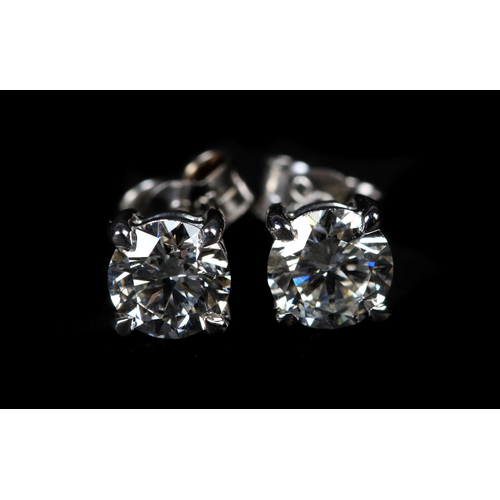 326 - A PAIR OF DIAMOND STUD EARRINGS in 18ct white gold, the brilliant cut stones claw set with post and ... 