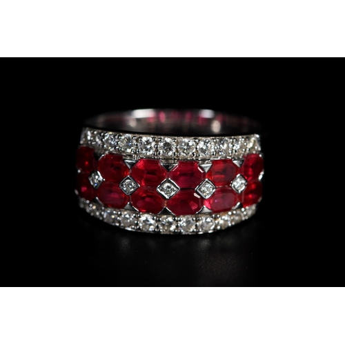 327 - A RUBY AND DIAMOND BAND RING IN 18CT WHITE GOLD, the brilliant cut diamonds and calibre cut rubies g... 