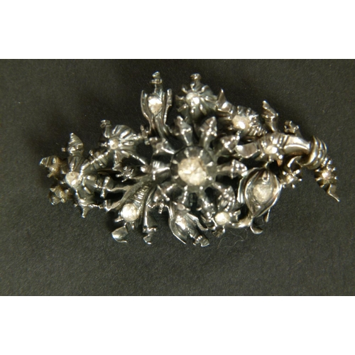 339 - A DIAMOND SPRAY BROOCH in silver, the rose cut stones in cut down setting within the pierced foliate... 