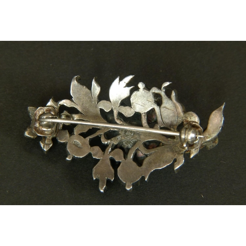 339 - A DIAMOND SPRAY BROOCH in silver, the rose cut stones in cut down setting within the pierced foliate... 