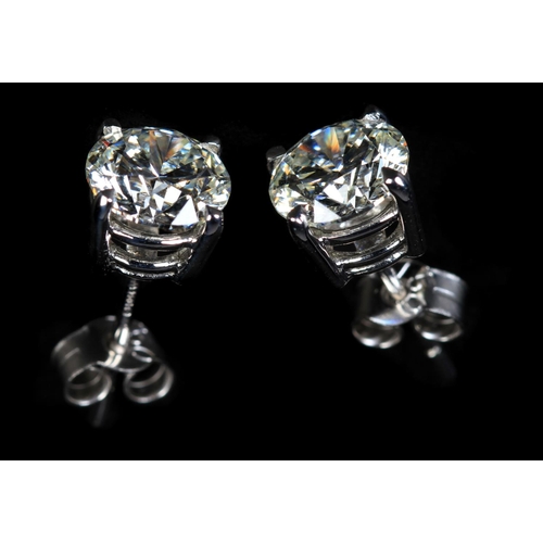 340 - A PAIR OF DIAMOND STUD EARRINGS in 18ct white gold the brilliant cut stones claw set with post and s... 