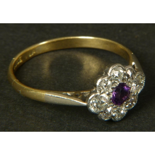 362 - AN AMETHYST AND DIAMOND CLUSTER RING in 18ct gold and platinum c.1920 set to the centre with a circu... 