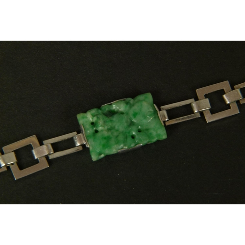 367 - A JADE BRACELET IN 14CT WHITE GOLD c.1945 the four rectangular pierced and carved plaques claw set a... 