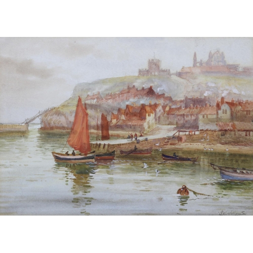 445 - J W WILLIAMS (fl.1900-1920) Whitby Harbour, cobbles heading out to sea, the town and abbey beyond, a... 