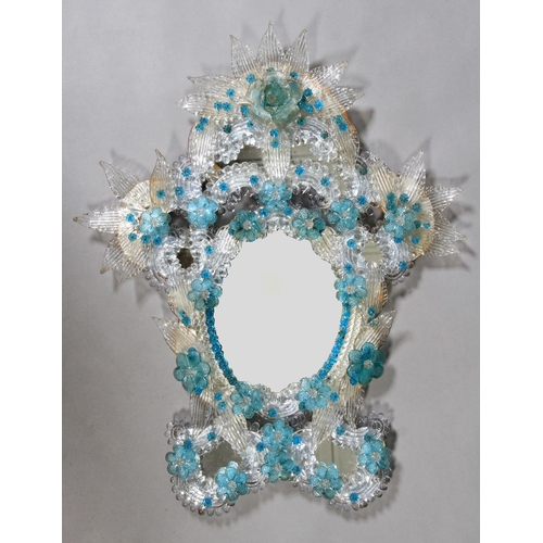 481 - A VENETIAN BLUE AND CLEAR GLASS MIRROR, of rococo cartouche form, profusely applied with moulded lea... 