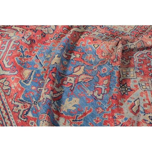 489 - A SURYVNA CARPET, West Anatolia the blue field with overall palmettes, vines and leaves within a con... 