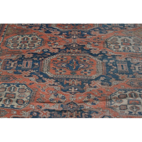 491 - A SOUMAC CARPET, East Caucasus the terracotta field with a column of four blue stepped medallions, o... 