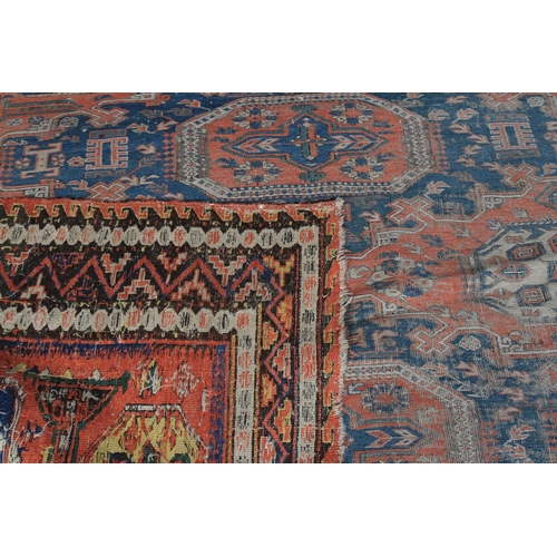 491 - A SOUMAC CARPET, East Caucasus the terracotta field with a column of four blue stepped medallions, o... 