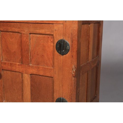 498 - A THOMPSON OF KILBURN 'MOUSEMAN' OAK BEDSIDE CUPBOARD, c.1935-40, having a short raised back, adzed ... 