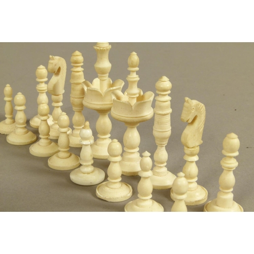 50 - A BONE AND RED STAINED BONE CHESS SET, king 9cm high, boxed