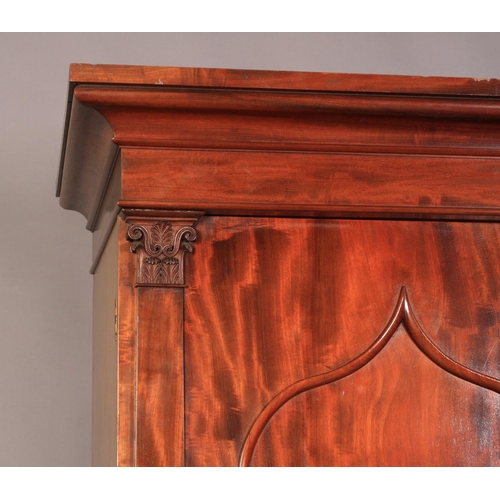 510 - A WILLIAM IV MAHOGANY CLOTHES PRESS with deep cavetto moulded cornice above a shallow frieze, pair o... 