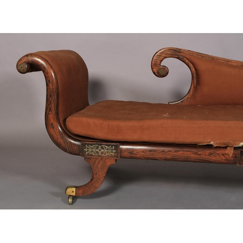 521 - A REGENCY FAUX ROSEWOOD DECORATED DAY BED, the back, scrolling arm and seat upholstered in brown rep... 