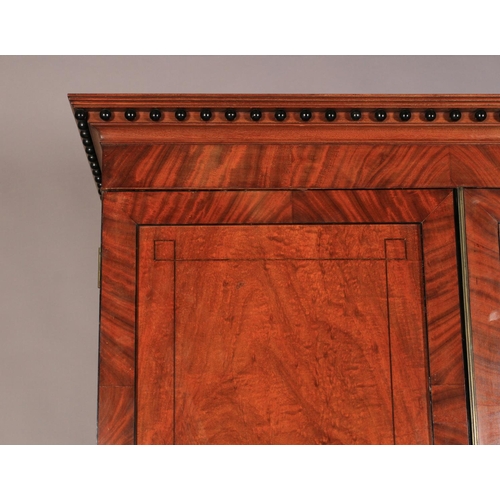 531 - A REGENCY MAHOGANY CLOTHES PRESS, ebony strung throughout, the flared cavetto cornice applied with e... 