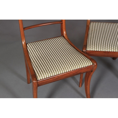 543 - A SET OF FOUR REGENCY MAHOGANY SABRE LEG DINING CHAIRS with figured concave cresting rails and mould... 