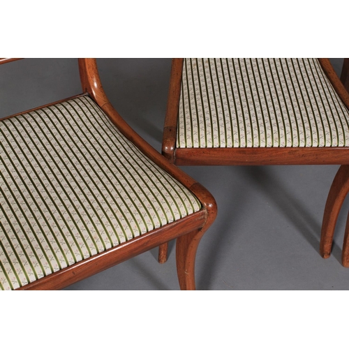 543 - A SET OF FOUR REGENCY MAHOGANY SABRE LEG DINING CHAIRS with figured concave cresting rails and mould... 