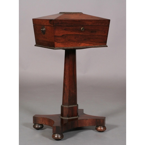 544 - A REGENCY ROSEWOOD VENEERED TEAPOY of conventional form, the sarcophagus shaped top with reel mouldi... 