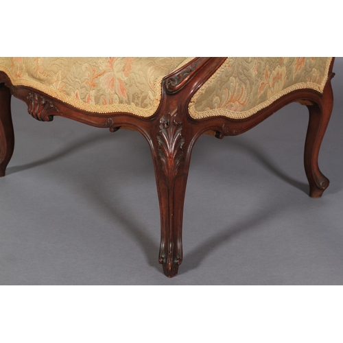 548 - A LATE 19TH CENTURY WALNUT WINGED ARMCHAIR having a moulded encircling frame with shell cresting, up... 