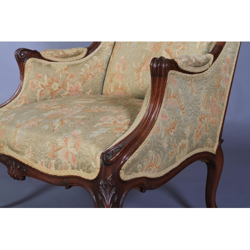 548 - A LATE 19TH CENTURY WALNUT WINGED ARMCHAIR having a moulded encircling frame with shell cresting, up... 