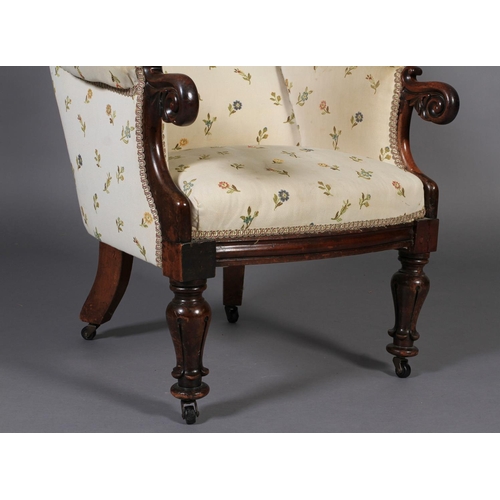 552 - AN EARLY VICTORIAN MAHOGANY ARMCHAIR having an encircling frame, foliate carved and scrolled arm ter... 